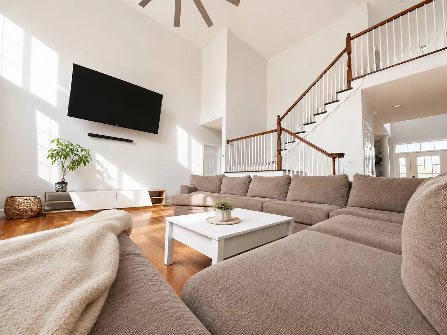 Actual two-story Augusta Lane living room with fireplace and oversized windows